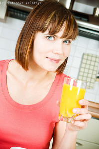 Young woman drinking orange juice